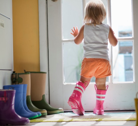 Child looking out door